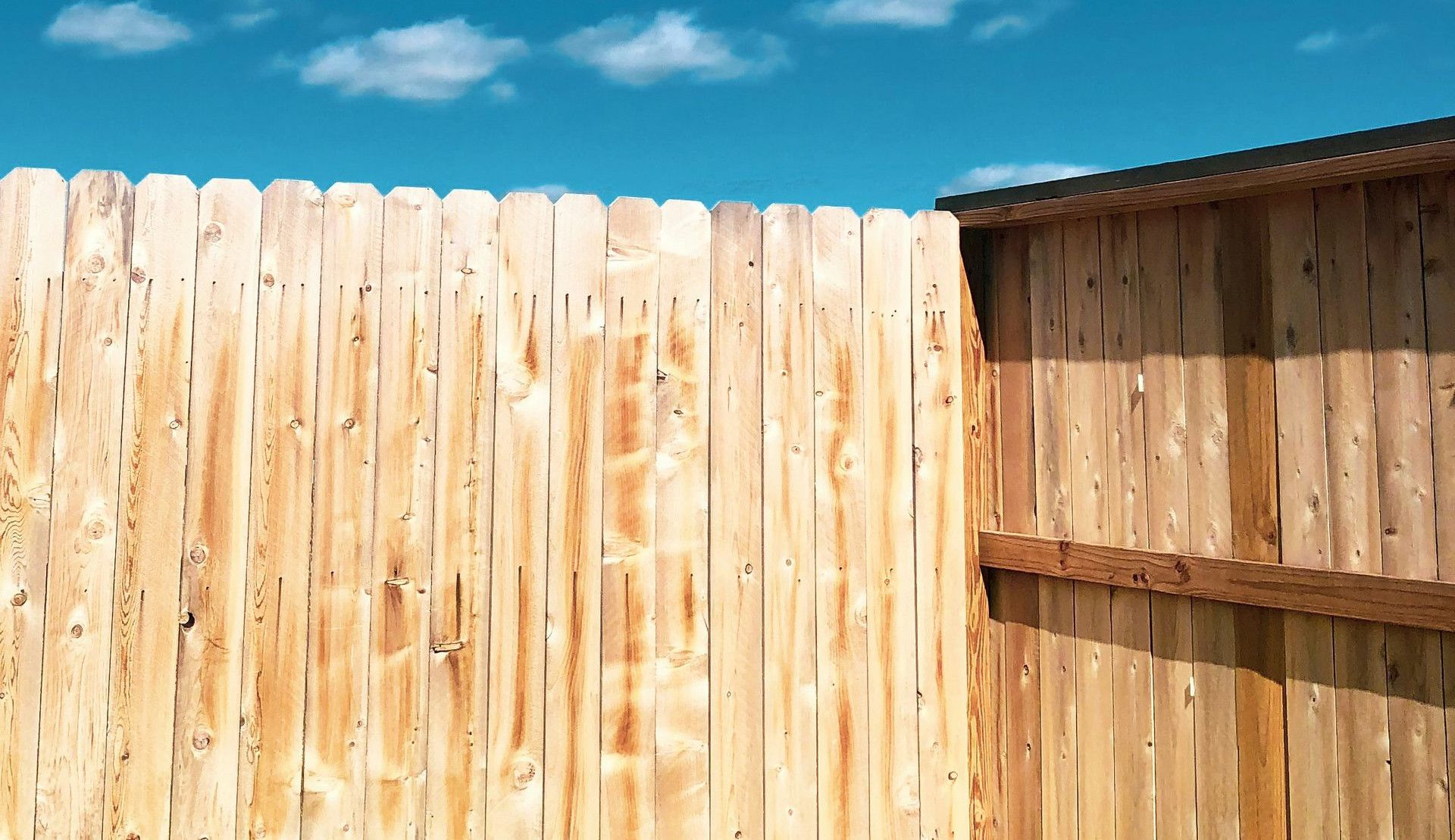 brown wooden fence under blue sky during daytime